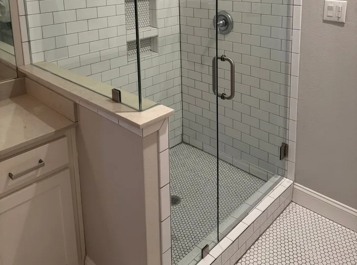 Frameless glass shower installed during a DFW bathroom remodel