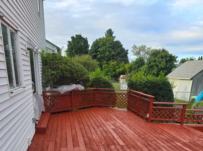 Backyard deck rebuilt and re-stained red by Sanders and Sons
